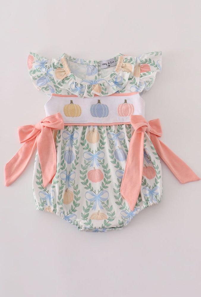 Baby romper with floral and pumpkin design on a light gray background