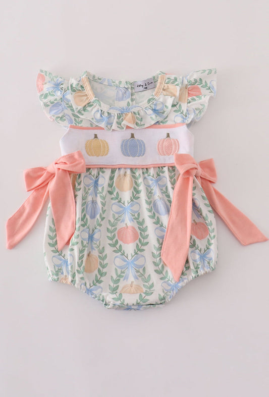 Baby romper with floral and pumpkin design on a light gray background